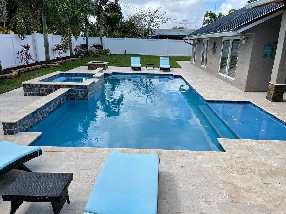 Finished pool filled with water, koi fish design visible beneath the surface