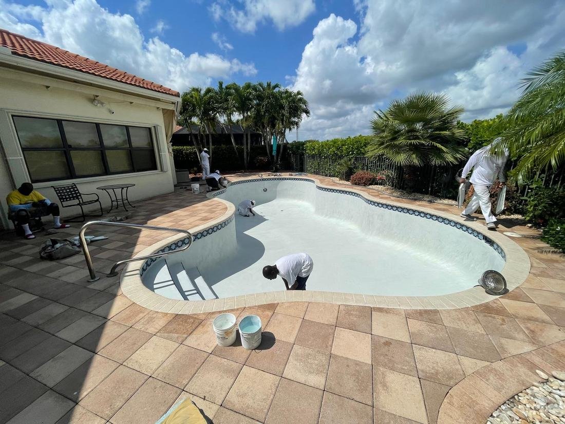 Freeform pool freshly resurfaced with white plaster, before filling