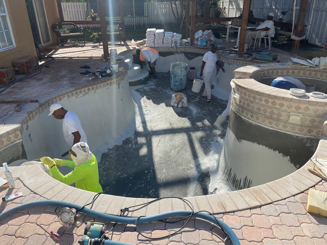 Crew plastering a pool and spa shell